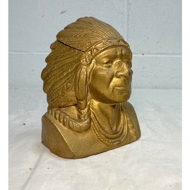 The Vintage Original Indian Head National Bank Cast Iron Still Bank is a unique and collectible piece that originated from...