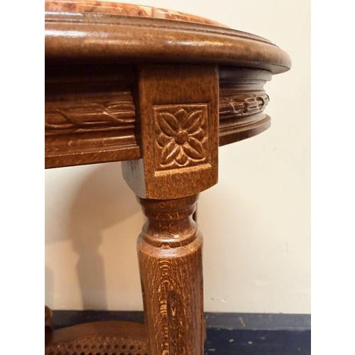 Beautiful French carved fruitwood oval side table, often referred to as a plant stand. Features an elegant rouge marble...