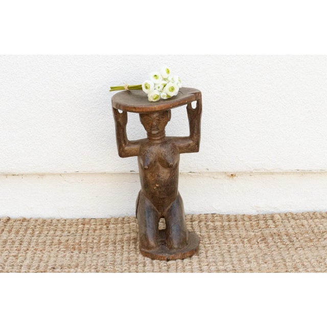 A masterpiece of African art, this antique Luba stool showcases a stunningly carved woman holding up the seat. The wax-...