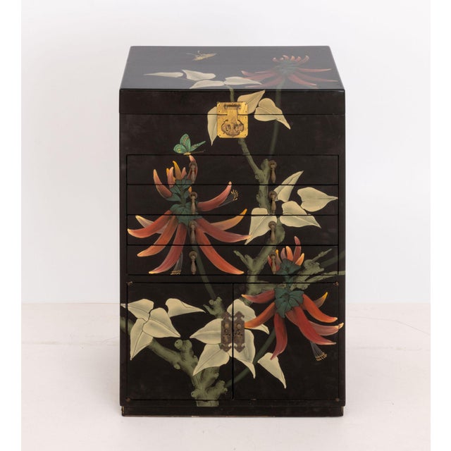 Chinese Floral Motif Hand-Painted and Black Lacquered Cabinet, the lift top opening to black velvet lined fitted...