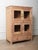 This vintage wooden glass-front cabinet features clean lines, beautiful natural wood tones, and four framed doors—two...