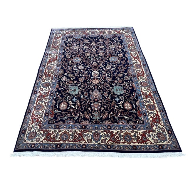 Persian Kashan rug, hand-knotted in Pakistan from 100% wool. Measuring 5’6” x 7’9”, the rug features an elegant all-over...