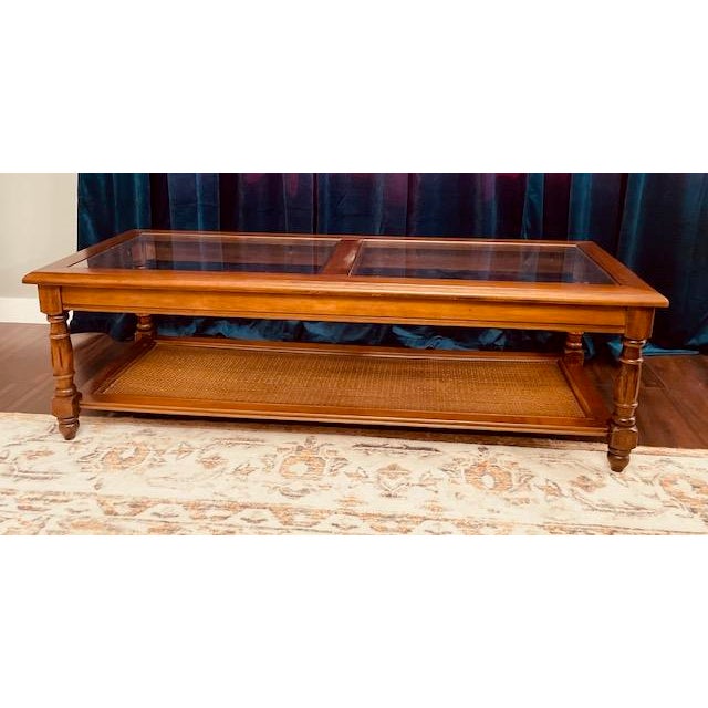 Bring timeless traditional style into your home with this beautifully crafted vintage glass-top coffee table. Featuring...