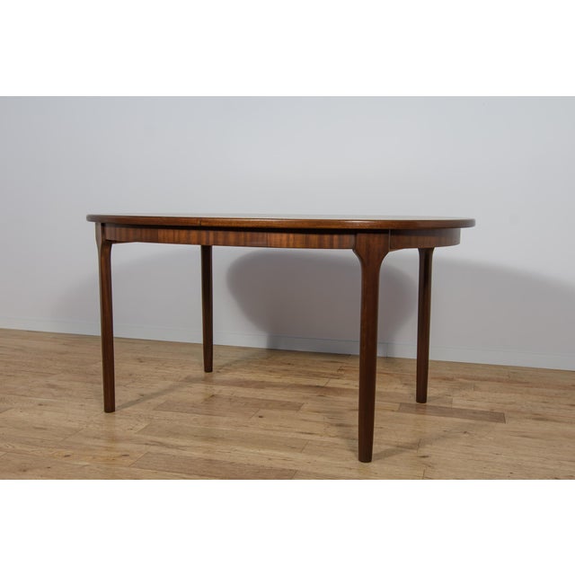 This oval extendable dining table was produced by McIntosh in the 1960s. Teak elements cleaned old surface and painted in...