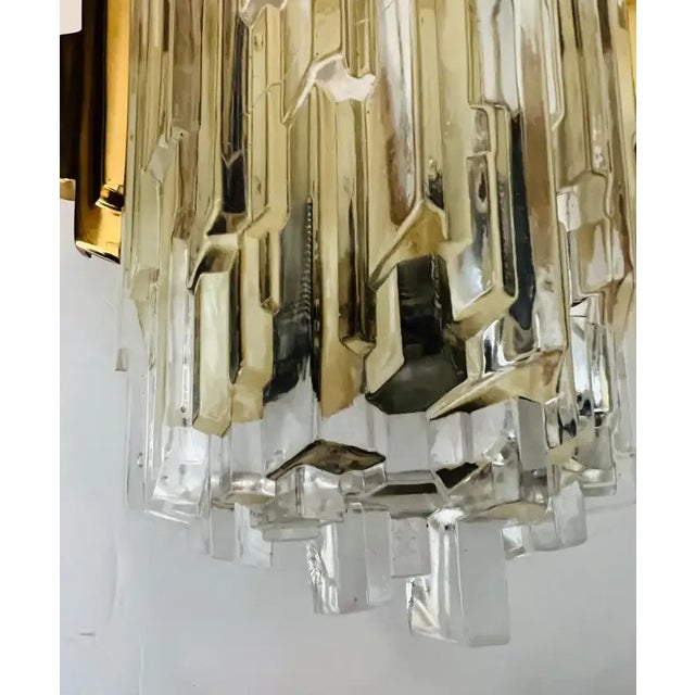 Pair of luxurious 1970s ice shaped crystal wall lights with golden polished brass fittings. Made by the German company,...