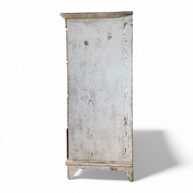 A refined example of 19th-century Swedish folk cabinetmaking, this painted reeded chest presents an elegant yet...