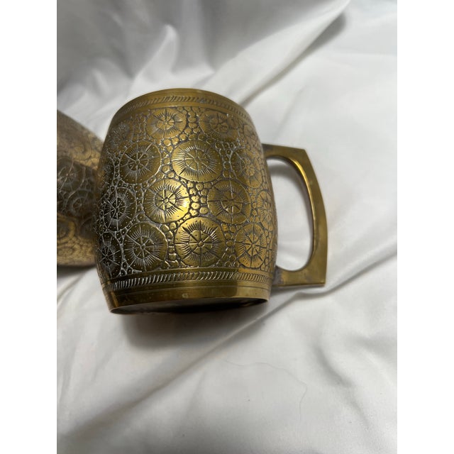 Very cool mid century brass tankards with a tooled floral design all around. These rare mugs are a great way to add a...