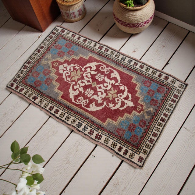 Vintage Turkish hand-knotted small rug from the Aegean region, 1960, featuring warm brick-red tones and authentic village...