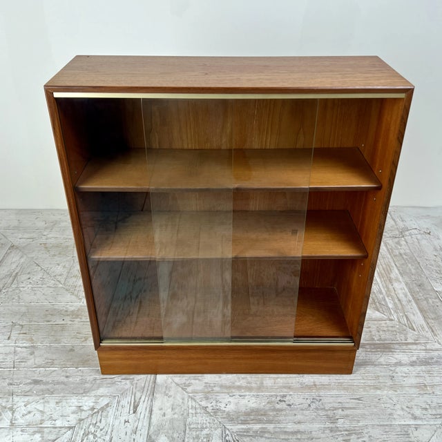 A smart Midcentury Bookcase by Minty of Oxford (Four available). Crafted with a focus on clean lines and a rich wood...