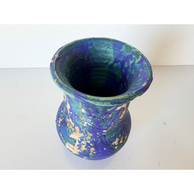 Striking vintage ceramic vase from the 1980s featuring an expressive blue and green drip glaze over an organic form. The...