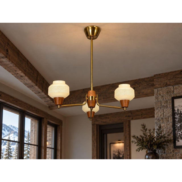 Swedish Mid-Century Modern, Pendant Light or Chandelier, Brass, Teak, Textured Glass, 1950s A three light pendant light or...