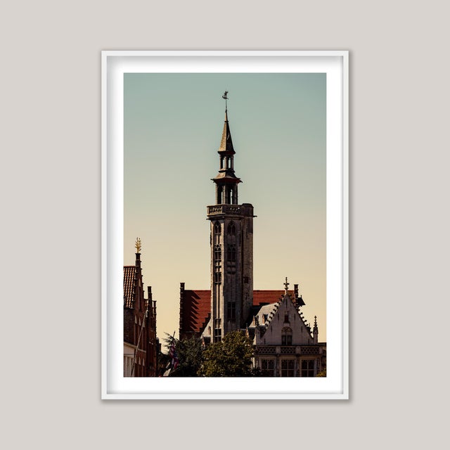 A late-summer photograph of the Poortersloge (Burghers’ Lodge) in Bruges, Belgium — its historic Gothic façade bathed in...