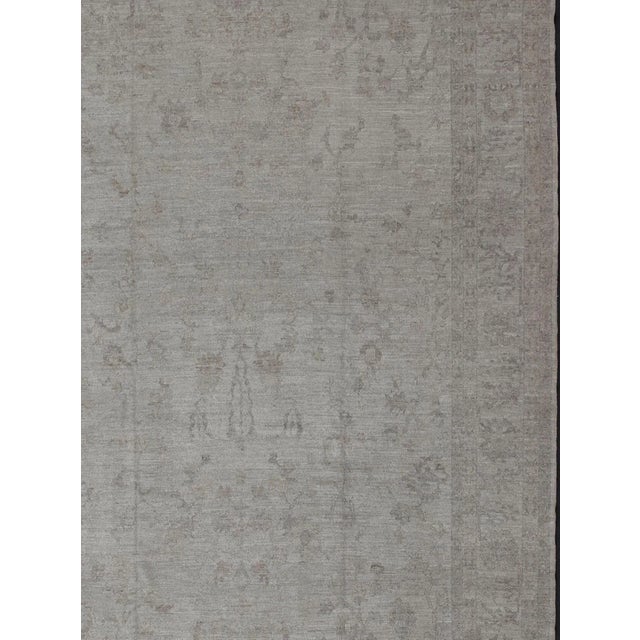 Measures: 12'5 x 18'5 Keivan Woven Arts Large Angora Turkish Oushak Rug in Cream, Taupe, Silver, and Hints of Faded Blue....
