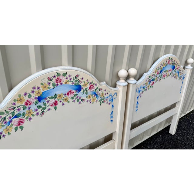 A pair of vintage hand painted floral twin headboards. Indicative of the 90’s through and through with chintzy motifs of...