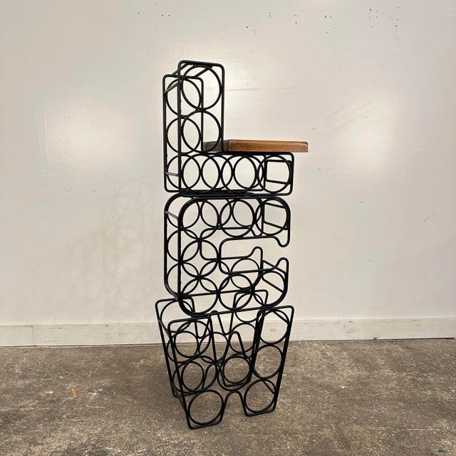 Mid century modern Arthur Umanoff style Iron & Wood Wine Rack. This unique wine rack hold 19 bottles and is in the shape...