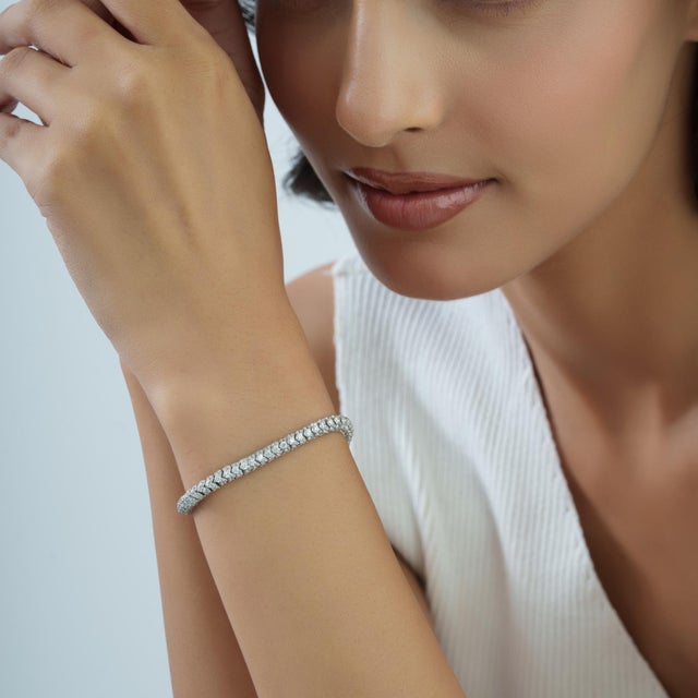 This 7-inch vintage-style eternity bracelet features a single continuous row of natural white zircon gemstones in a 925...