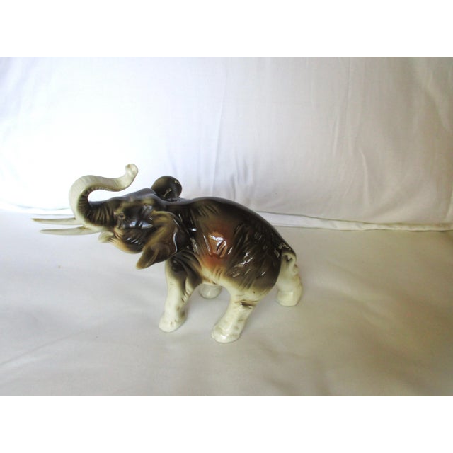 This is a Gorgeous Vintage Royal Dux Amphora Porcelain Charging Elephant with ahigh gloss finish in beautiful colors of...