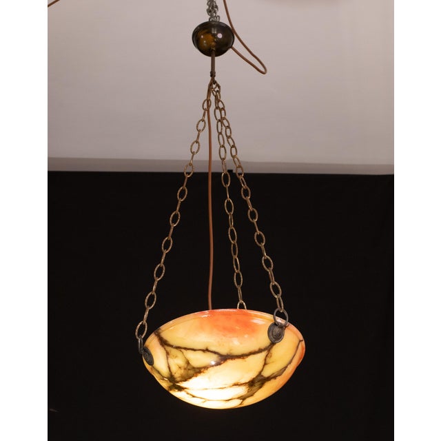 Extraordinary red alabaster pendant chandelier with black and orange antique shades in Art Deco style, circa 1940s. A...