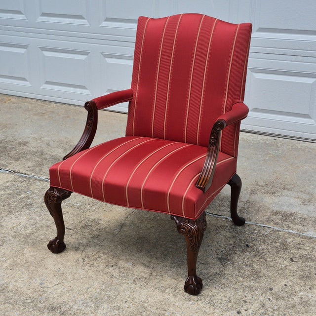 This is a traditional chippendale style carved mahogany Gainsborough chair by high-end American furniture company Hickory...