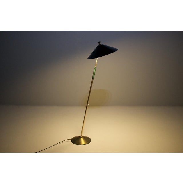 Modernist lamp in solid brass, the bait tilted through a ball joint set in it the reflector, also tilting, can compensate...
