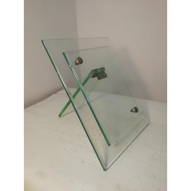 Beautiful and rare tabletop photo frame in Nile green glass. A beautiful, deep color. Brass and metal inserts. A truly...