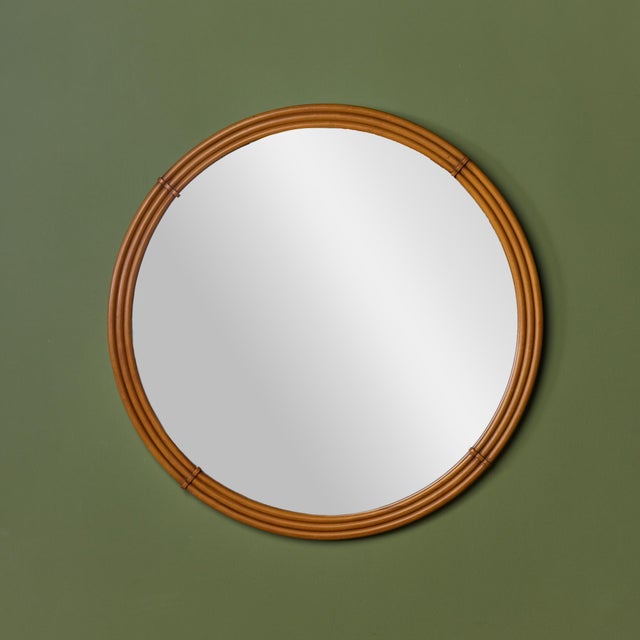 Round wall mirror surrounded in a maple stacked, triple-banded frame. The natural warmth of the maple is accented by...