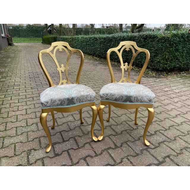 1950s French Louis XVI–Style Gold-Finished Side Chairs with Damask Upholstery – Pair This elegant pair of French Louis...