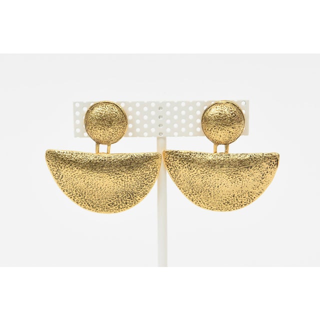 These interesting vintage gold plated dangle clip on pagoda or moon form earrings have a semi texture surface almost like...