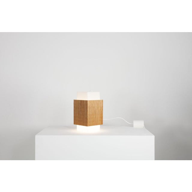 This Italian hanging lamp comes from the 60s. It is rectangular and consists of a acrylic screen surrounded by bamboo. The...