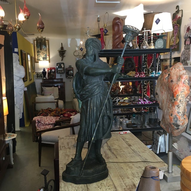 Strong Moorish- style statuesque warrior holding a torchlight. The detail is magnificent. His turban, neck-cover, face,...