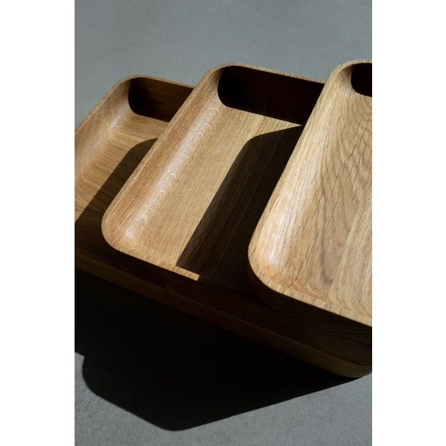 The JOYO set is a modular trio of stackable oak trays – Small, Medium, and Large – that nest and stack to organize a desk,...