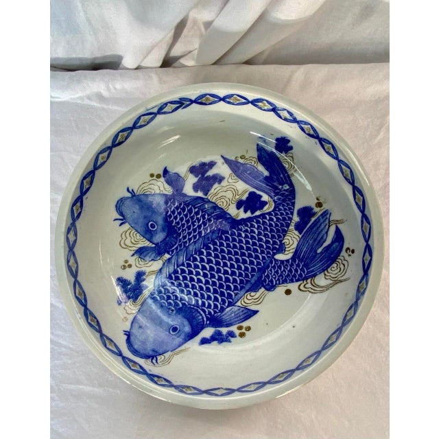 Hand-painted Japanese Imari porcelain bowl dating to the Edo period, decorated in underglaze cobalt blue with two...