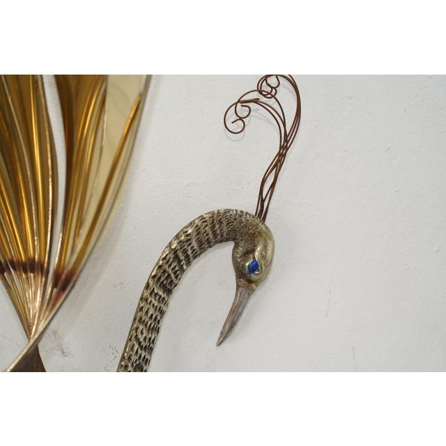 Incredible sense of movement and depth with layered brass “feathers,” sculptural wirework, and a sweeping silhouette that...