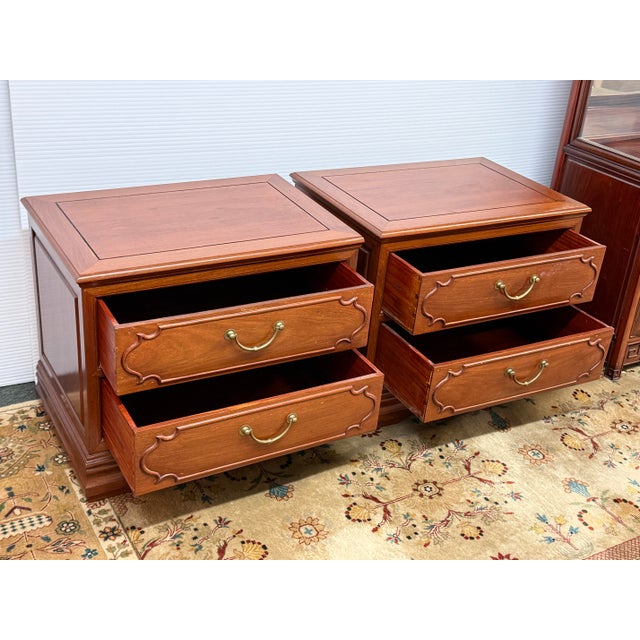 Design Plus Gallery presents a Pair of Vintage Rosewood Nightstands. Each nightstand has a framed panel top, paneled...