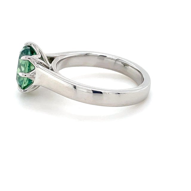 This unique AGL unheated demantoid garnet ring is full of fire and color! In an antique pear shape and surrounded by...