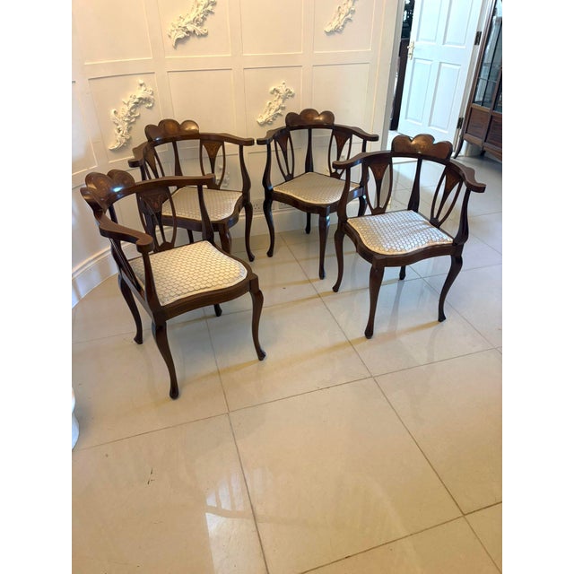A very unusual and elegant set of four antique Edwardian mahogany corner chairs, beautifully designed to sit neatly into...