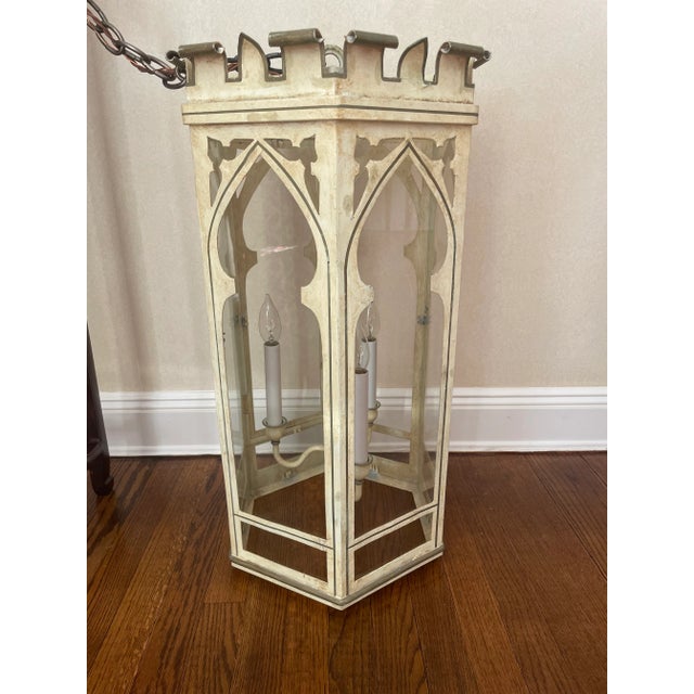 This stunning lantern is Septagonal in shape with arched glass windows and a parapet top. It has a 3 armed pendant for...