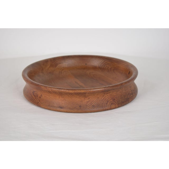 Finnish-made wooden bowl, signed and handcrafted, featuring clean lines and the warm, natural grain of the material. The...