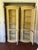 A matched pair of Drexel Heritage Et Cetera corner cabinets in their original cream glaze with hand-painted sepia scroll...