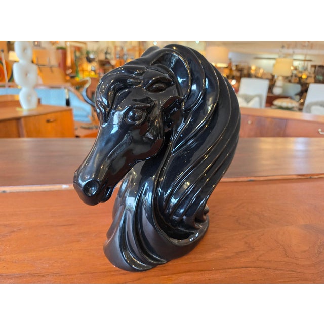 This dramatic Art Deco style black ceramic horse head sculpture features sweeping, stylized layers that create a bold...