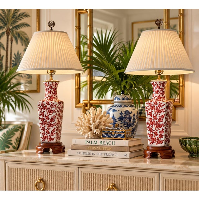 Beautiful pair of vintage 1960s Chinese-style porcelain table lamps featuring elegant hand-painted red cherry blossom...