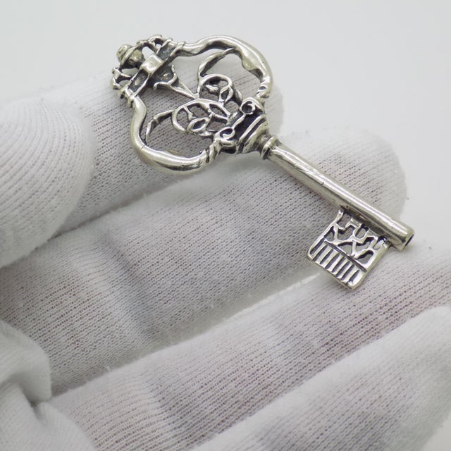 A refined vintage decorative key, life size, handmade in Continental Silver (800/000) in Arezzo between the 1980s and...