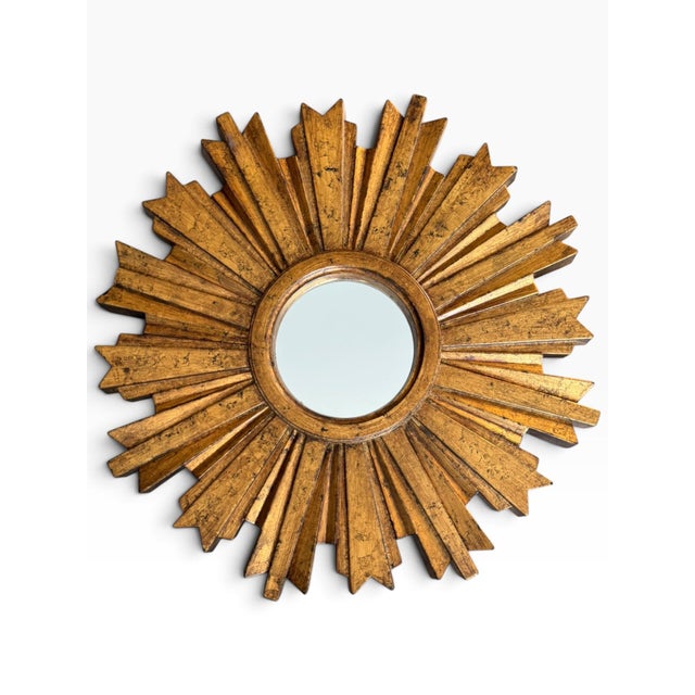 Vintage gold sunburst mirror with a dramatic dimensional starburst design and sculptural molded construction. Featuring...