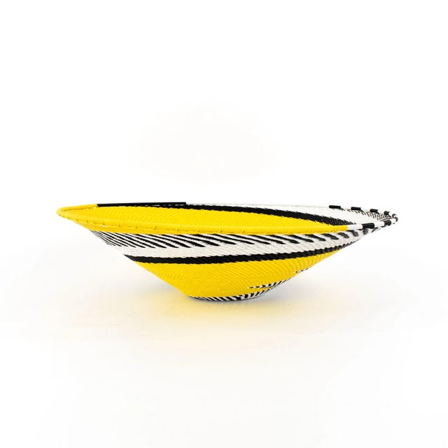 Zulu Telephone Wire Baskets from South Africa epitomize the fusion of traditional craftsmanship and contemporary...