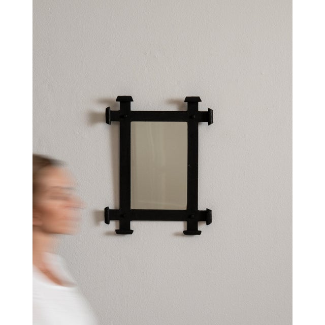 This mirror makes its impression through black chunky frame with turned finial accents. It was made in France during 20th...