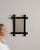This mirror makes its impression through black chunky frame with turned finial accents. It was made in France during 20th...