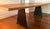 Solid Walnut Dining table with tapered 2 inch top. Wax finished. Blackened Oak legs supported on steel frame. Narrow at...