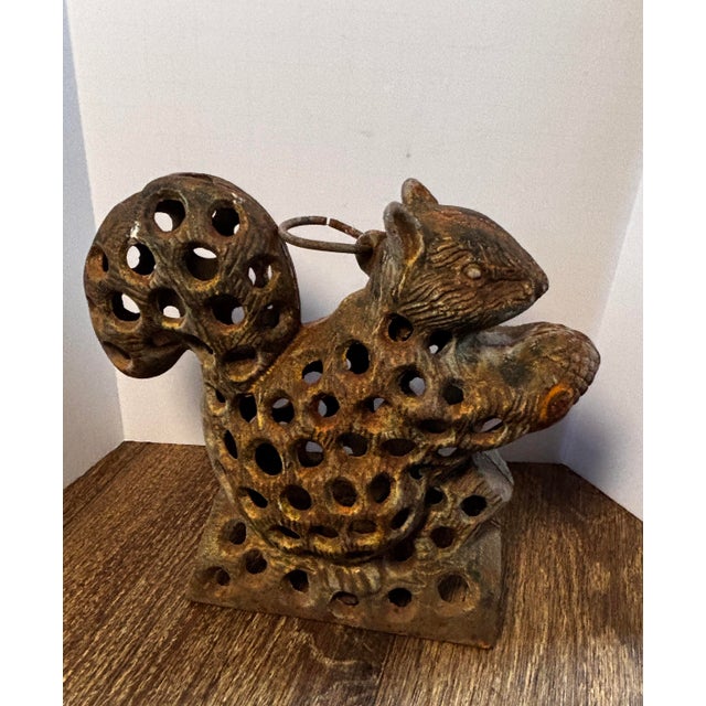 This item is a Japanese cast iron garden squirrel lantern. The lantern’ has holes allowing light to pass through. It is...
