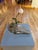 Adrift by Ashley Folkner | Mixed Media Sculpture of driftwood with a dandelion flower For Sale