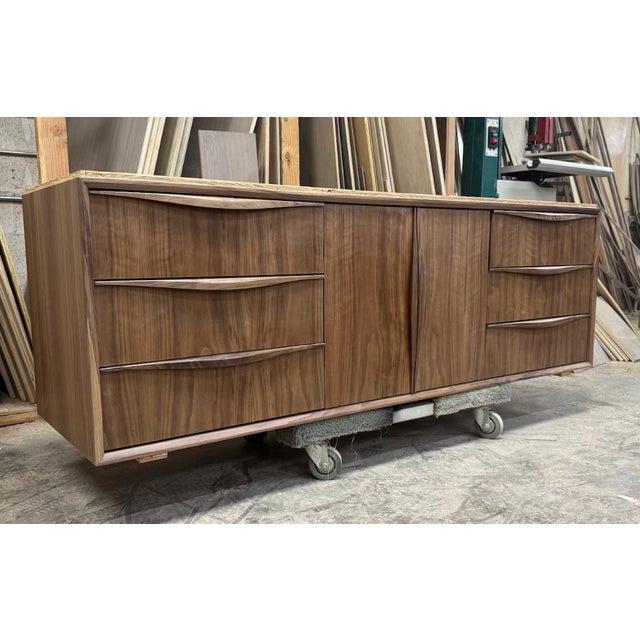 Our 68” Mid Century Floating Bathroom Vanity features curved drawer fronts and integrated pulls, this walnut vanity...